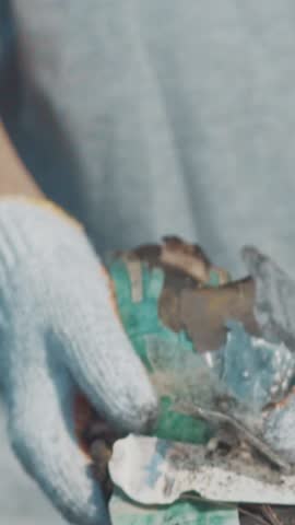 On a sunny day in Bali, a dedicated volunteer gathers plastic debris scattered across the sandy shores. Their efforts highlight the urgent need for environmental conservation and cleaner oceans.