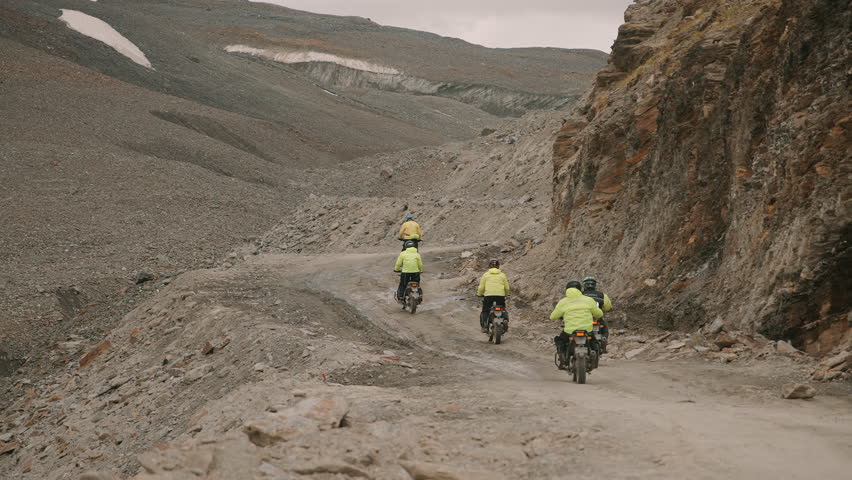 Bikers Riding on Rocky Mountain Road
