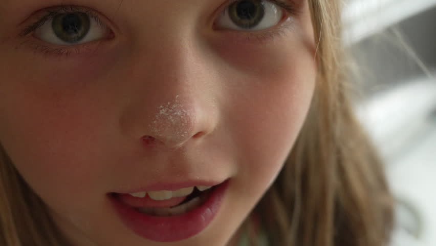 Close-up Portrait of a Young Girl with Powder on her Nose
