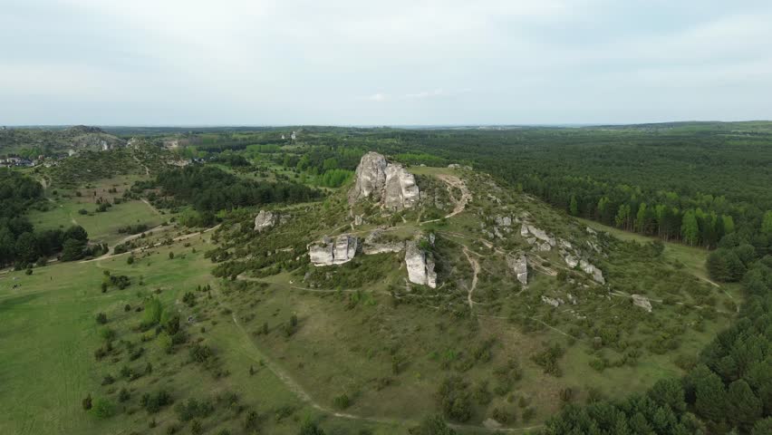 Natural rock formation on grassy hillside