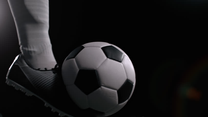 Super Slow Motion Shot of Kicking the Ball on Black Background at 1000fps.