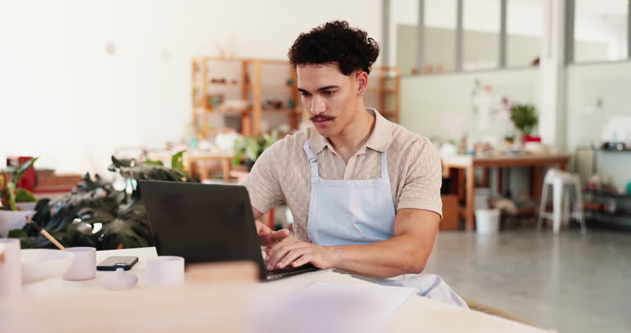 Man, creative and laptop in workshop for pottery, inventory management and clay order. Small business, artisan or entrepreneur typing in startup for ceramics sales, craft checklist or stock supply