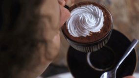Vertical screen close up of a woman enjoying a cup of hot chocolate topped with whipped cream, savoring the rich flavor and warmth of the beverage - Powered by Shutterstock - Get 15% off with code: PIKWIZARD15
