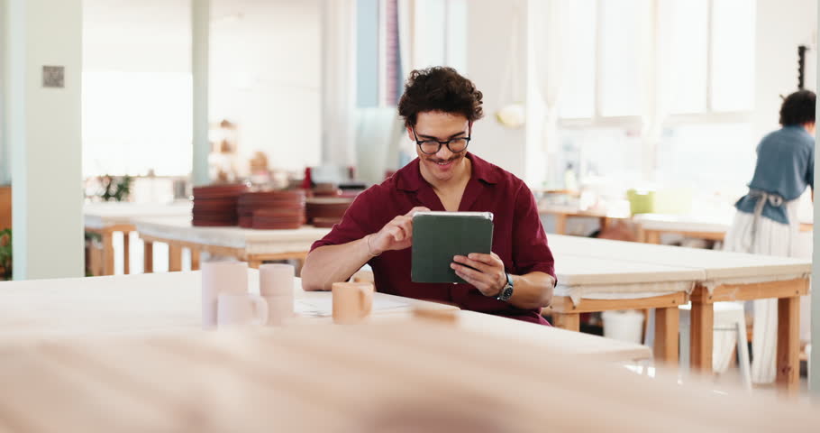 Man, creative or tablet in workshop for ceramics, inventory management or clay order. Small business, craft checklist or entrepreneur on touchscreen for pottery sales, artistic mug or stock supply