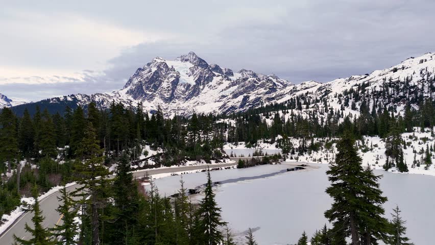 Cinematic Drone Footage Over Mount Baker — Majestic Snowy Mountains and Evergreen Forest in Winter Light. USA Landscape and wild nature from above