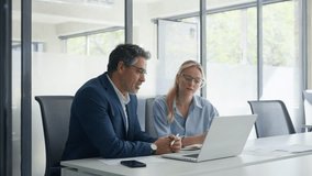 Two partners, team of professional business people working, studying, writing notes at desk. Senior mentor leader man teaching young trainee woman manager using laptop app in modern office workplace - Powered by Shutterstock - Get 15% off with code: PIKWIZARD15