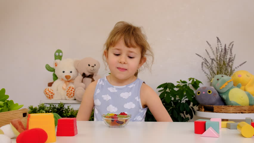 Child with jelly candies. Selective focus.