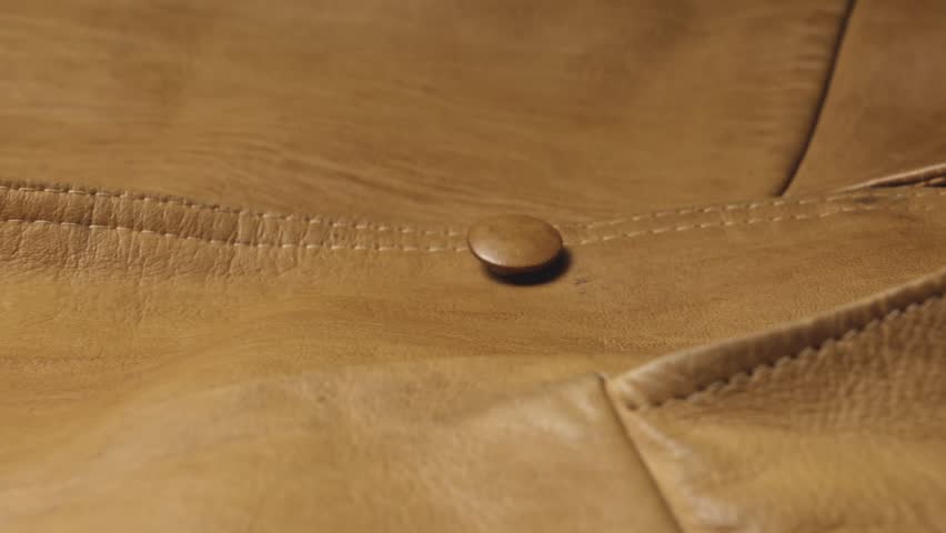 Brown Leather fashion jacket texture with stitched button seams SLIDE SHOT