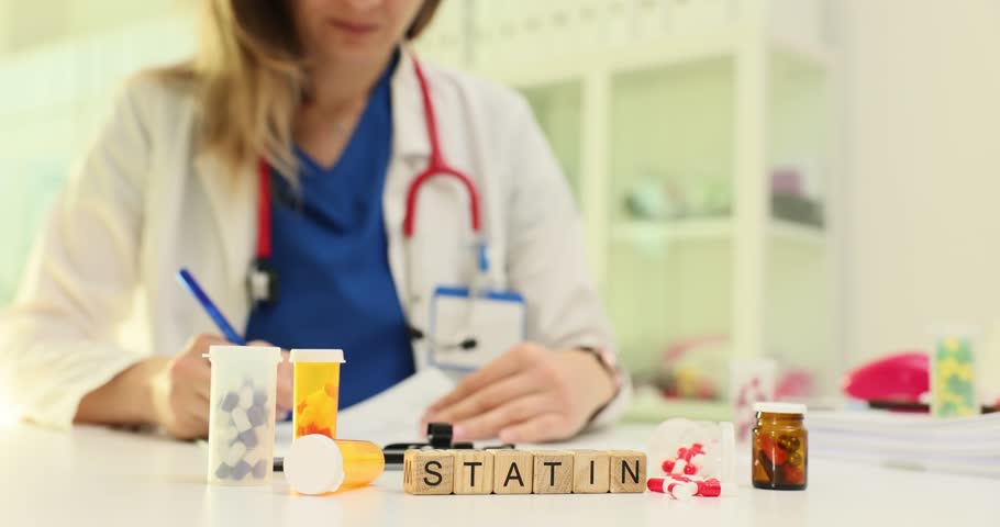 Woman doctor writes prescription for Statin medication. Experienced physician notes correct dosage and frequency for Statin treatment at appointment