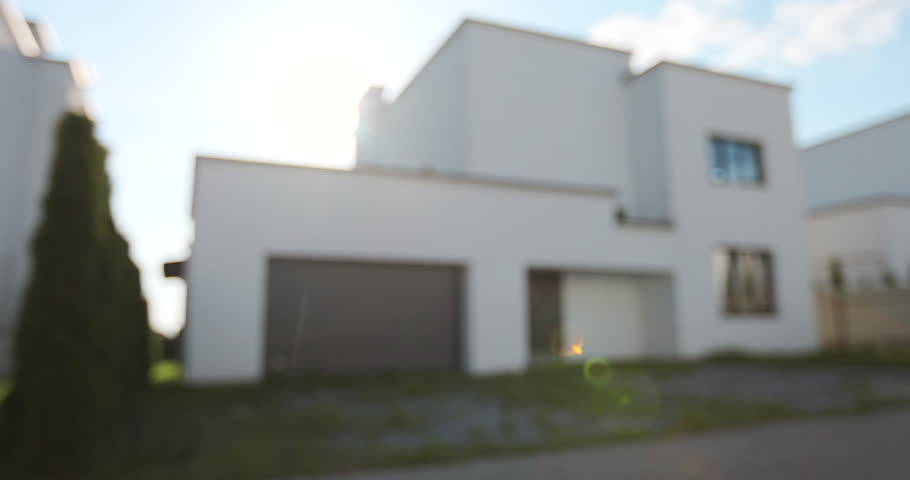 Woman holding keys to new house. Moving to a new home, mortgage, buying real estate, renting and booking housing, dream of living in the village.