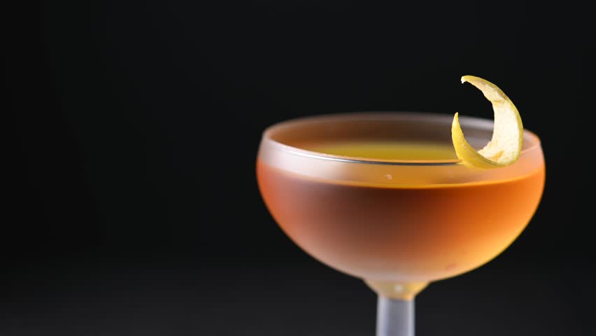 Rotating Paper plane cocktail on black slate background