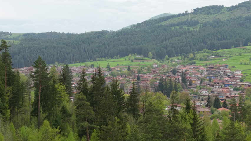 erial perspective of Koprivshtitsa in the Topolnitsa valley, famous for its role in the April Uprising. Surrounded by scenic meadows and Sredna Gora’s green hills,