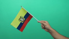 Man holding ecuador flag against green background, showcasing pride and identity. - Powered by Shutterstock - Get 15% off with code: PIKWIZARD15