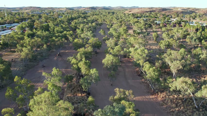Aerial footage moving forward along the Todd RIver in the late afternoon. Alice Springs, Mparntwe, Northern Territory, Australia. August 2022.