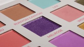 Shot of a glitter purple eyeshadow and brush. - Powered by Shutterstock - Get 15% off with code: PIKWIZARD15