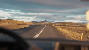 Road trip with car driving on highway among volcanic remote wilderness in Icelandic highlands at the sunset - Powered by Shutterstock - Get 15% off with code: PIKWIZARD15