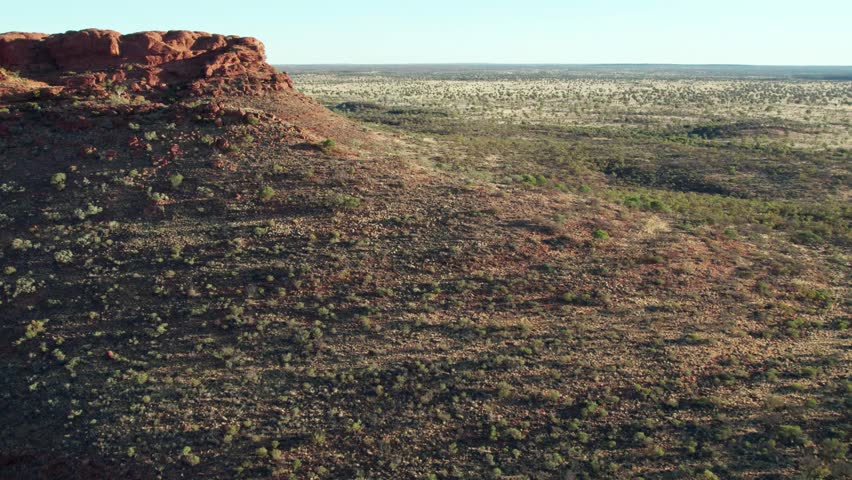 Aerial footage flying over a ridge near Kings Canyon, Watarrka, in the Northern Territory, Australia. August 2022.