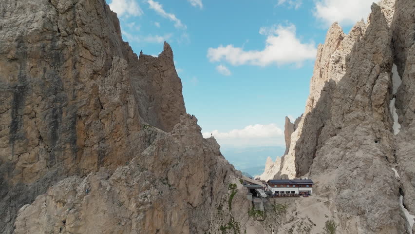 Panoramic view of the iconic Toni Demetz Hut perched dramatically in the Forcella del Sassolungo, Dolomites, Italy