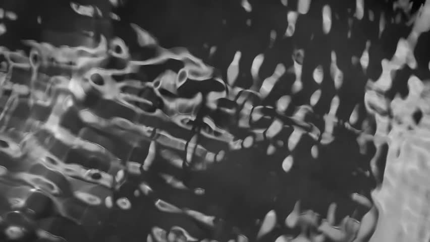 Abstract Water Texture: A black and white macro close-up photo of water droplets shimmering on a smooth surface, creating an abstract and organic texture. The ethereal.