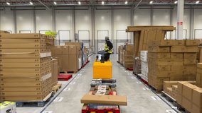 Forklift driver loads a truck trailer inside a warehouse. Logistics and freight handling in a professional industrial environment with safety gear - Powered by Shutterstock - Get 15% off with code: PIKWIZARD15