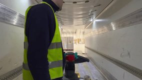 Forklift driver loads a truck trailer inside a warehouse. Logistics and freight handling in a professional industrial environment with safety gear - Powered by Shutterstock - Get 15% off with code: PIKWIZARD15