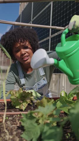 Urban farmer watering plants in slow motion