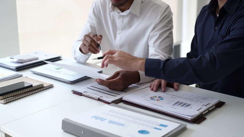 Two Business man team meeting present, investor colleagues discussing new plan financial graph data, analysis with laptop and digital tablet at work place - Powered by Shutterstock - Get 15% off with code: PIKWIZARD15