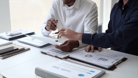 Two Business man team meeting present, investor colleagues discussing new plan financial graph data, analysis with laptop and digital tablet at work place - Powered by Shutterstock - Get 15% off with code: PIKWIZARD15