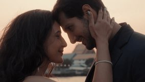 Portrait of passionate Latin couple touches foreheads sailing yacht at sunset closeup. Warm intimate moment of newlywed Hispanic partners enjoying romantic vacation in Thailand - Powered by Shutterstock - Get 15% off with code: PIKWIZARD15