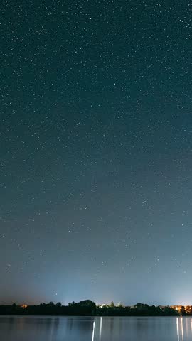 Lyepyel District, Vitebsk Province, Belarus. Real Colorful Night Stars Above Lepel Lake. Natural Starry Sky Background Backdrop Landscape. Time lapse. .