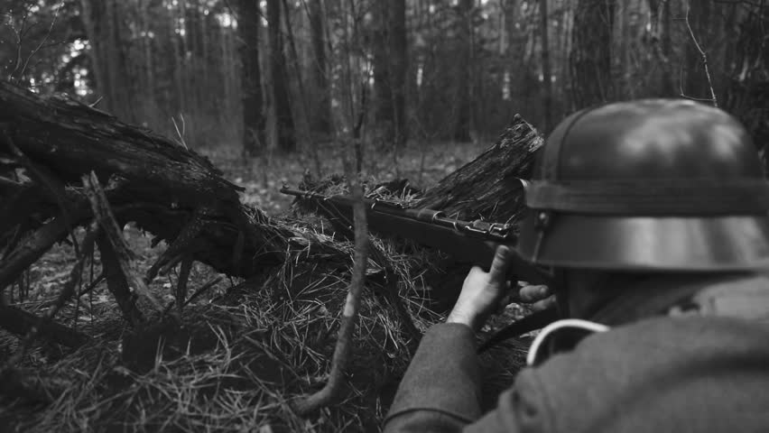 Historical Re-enactment Black And White Video. World War II German Wehrmacht Infantry Soldier Aiming Shooting And Reload Rifle in Spring Autumn Forest. Soldier Open Fire Fight Battle On Battlefield