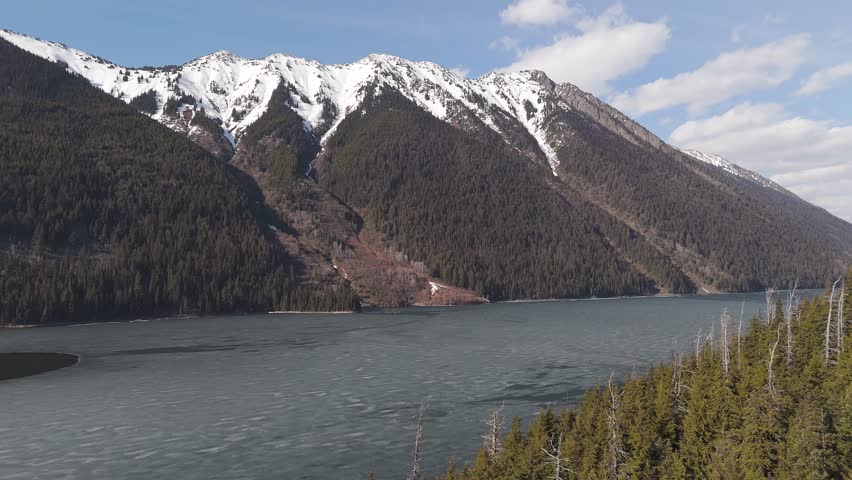 Frozen Lake and Snowy Mountain Range in British Columbia, Canada