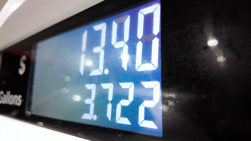 Petrol station with running numbers on gas pump at night time. Close up 