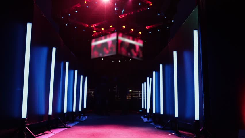 Empty corridor with blue and white lights leading to stage