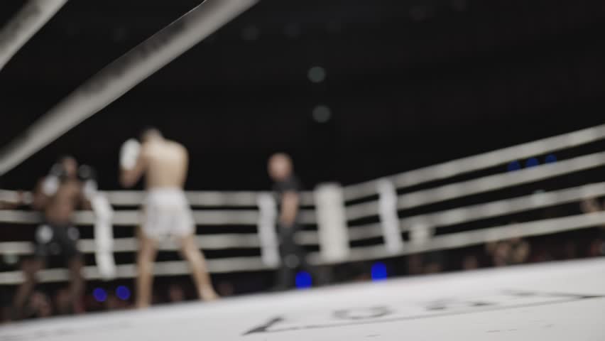 Blurred boxing match in slow motion from ringside view