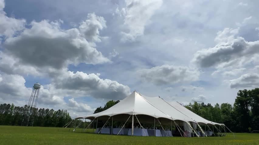 Beautiful outdoor tent under a cloudy sky, perfect for events and weddings