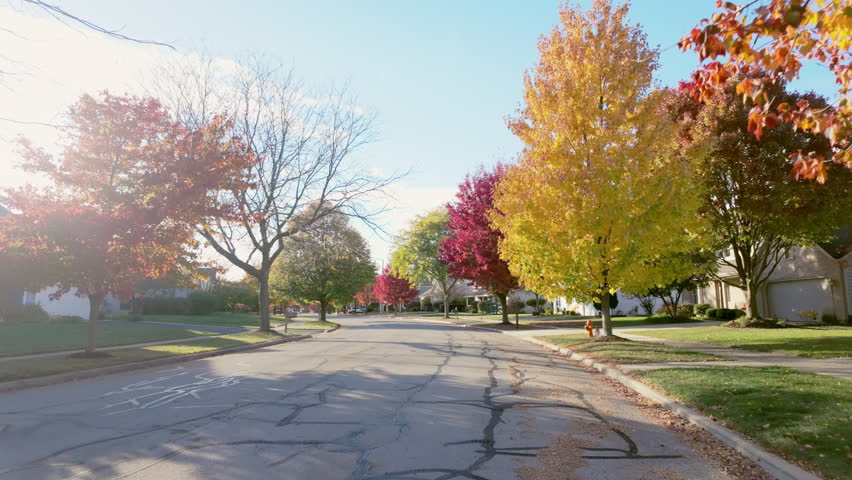 POV wide footage of suburban street in USA neighborhood on a beautiful bright sunny autumn day