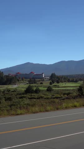 The Mount Washington Hotel sits before mountains on a sunny New Hampshire day