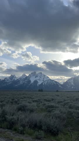 Snowy Teton peaks rise over a sagebrush plain in Grand Teton National Park