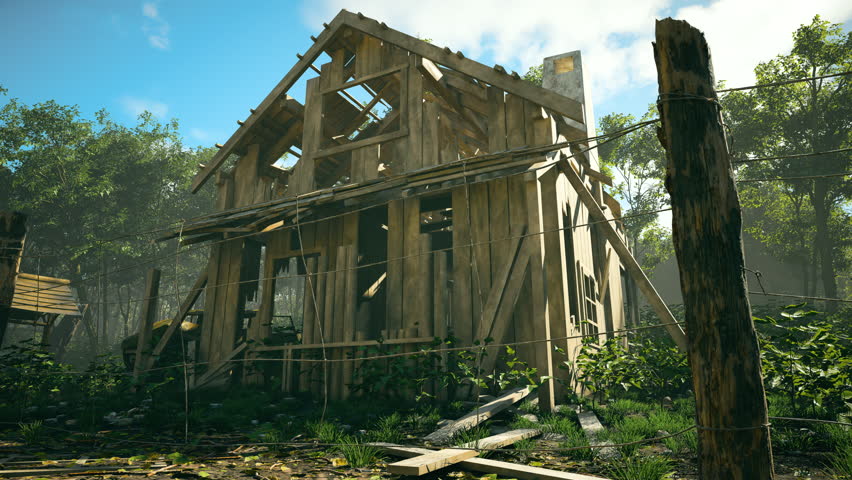 A partially destroyed wooden house frame stands in a forest clearing, surrounded by tall trees, scattered planks, and overgrown vegetation under a bright blue sky.