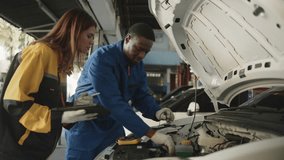 EV car check, mechanic workers coworker inspects and maintains service of electric engine and battery in fixed automobile garage station, professional technology transportation industry business. - Powered by Shutterstock - Get 15% off with code: PIKWIZARD15