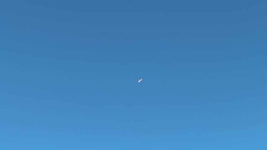 A passenger plane flying high up in the sky over the Cape Peninsula in South Africa.