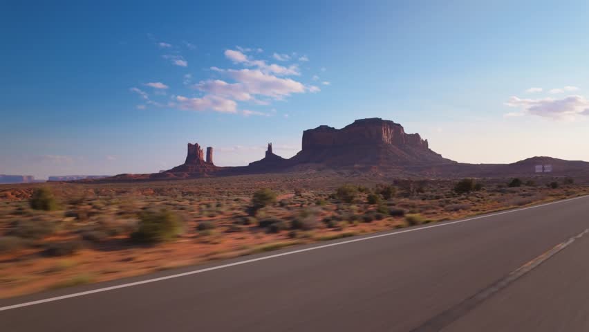 Take a scenic drive to Monument Valley to see the iconic red sandstone buttes against a clear sky, creating an unforgettable experience of the regions natural beauty and geological wonders