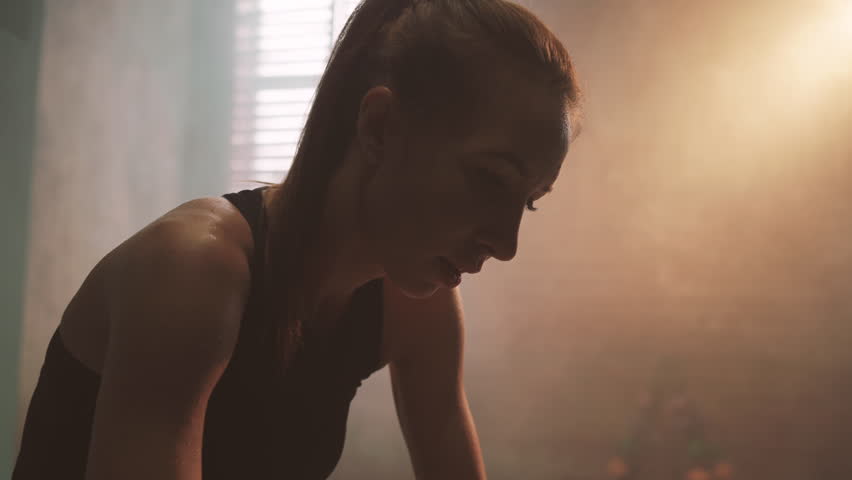 Beautiful blonde lady breathing hard after intensive workout in boxing club. Portrait of slender fragile woman recovery energy after cardio workout or fighting, be strong and self-confidence, do sport