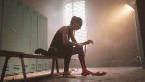 Exhausted sportswoman after hard cardio workout in changing room, be strong. Athletic feminine lady in skinny active wear, preparing to active boxing workout in gym, contrast of power and femininity - Powered by Shutterstock - Get 15% off with code: PIKWIZARD15