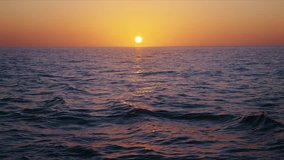 Experience a serene slowmotion sunset over the vast ocean, where vibrant colors reflect on gentle waves. This tranquil scene invites relaxation and inspires appreciation of natures beauty - Powered by Shutterstock - Get 15% off with code: PIKWIZARD15