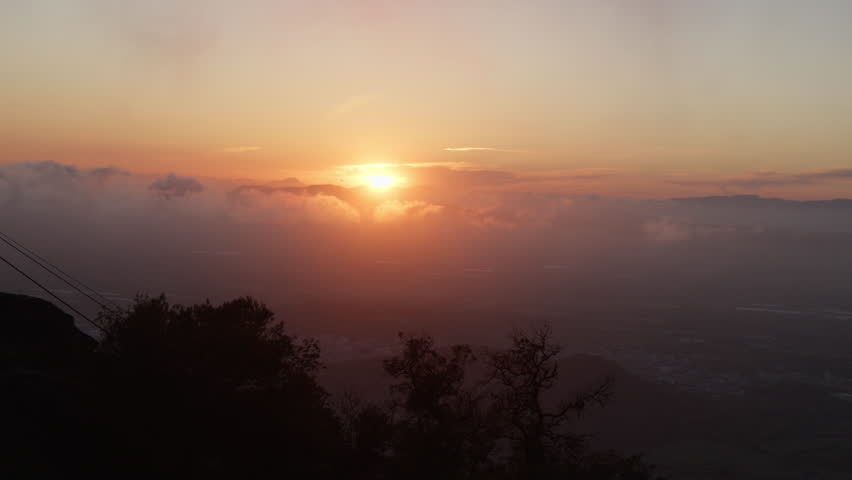 Serene Mallorca sunset over hills and trees. Ideal for travel documentaries showcasing natural beauty.