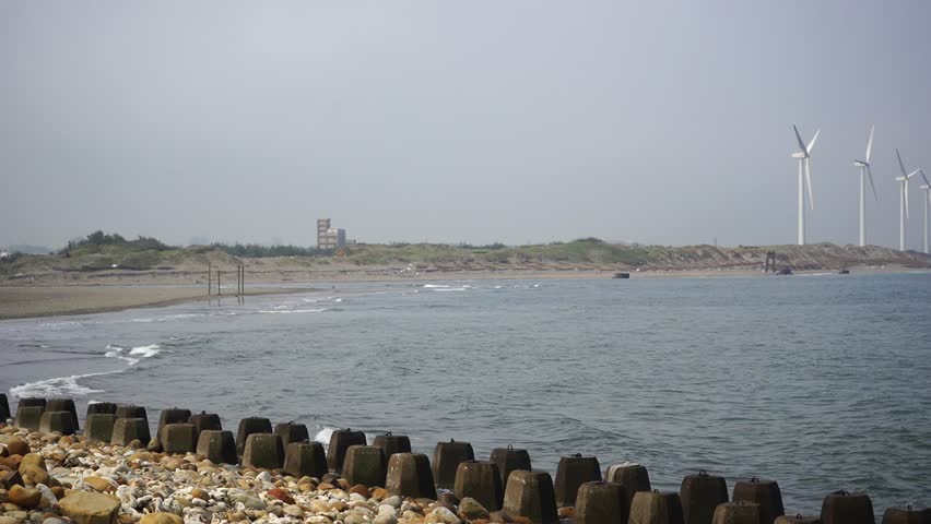 9 April 2025 - Gaomei Wetlands, Taiwan - A scenic view of the coastline, with windmills in the distance, capturing the natural beauty and sustainable energy of Gaomei Wetlands