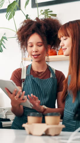 Coffee shop, talking and women on tablet in cafe for menu items, inventory and online orders. Restaurant, hospitality and people in conversation with digital tech for planning, invoice and service