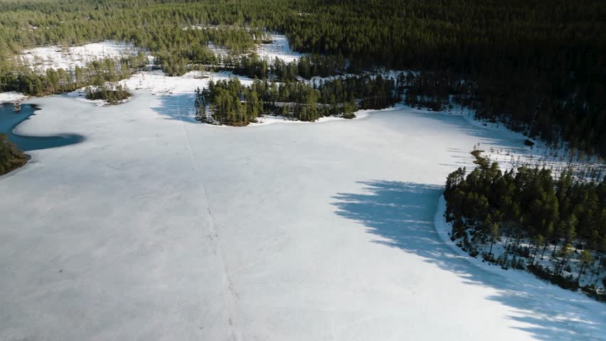 Drone orbit over frozen lake Rädsjön in Dalarna Sweden